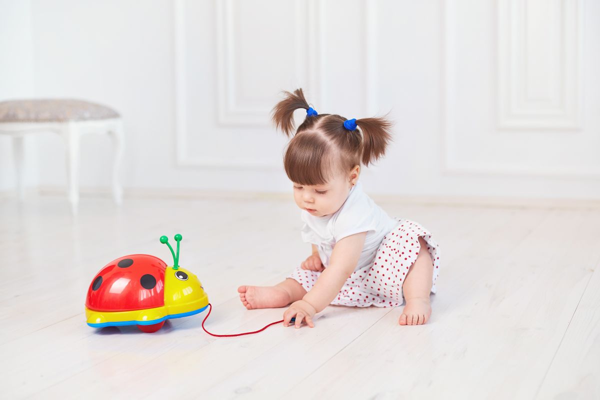 A two-year-old stacking large soft blocks